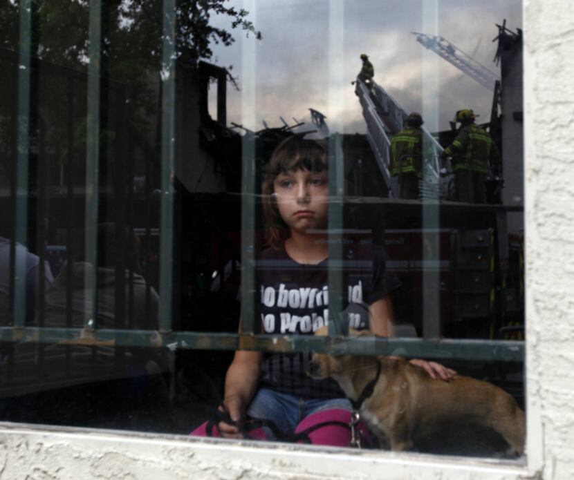 Chyanne Crouch, 9, watched from a window in her apartment building as firefighters battled...