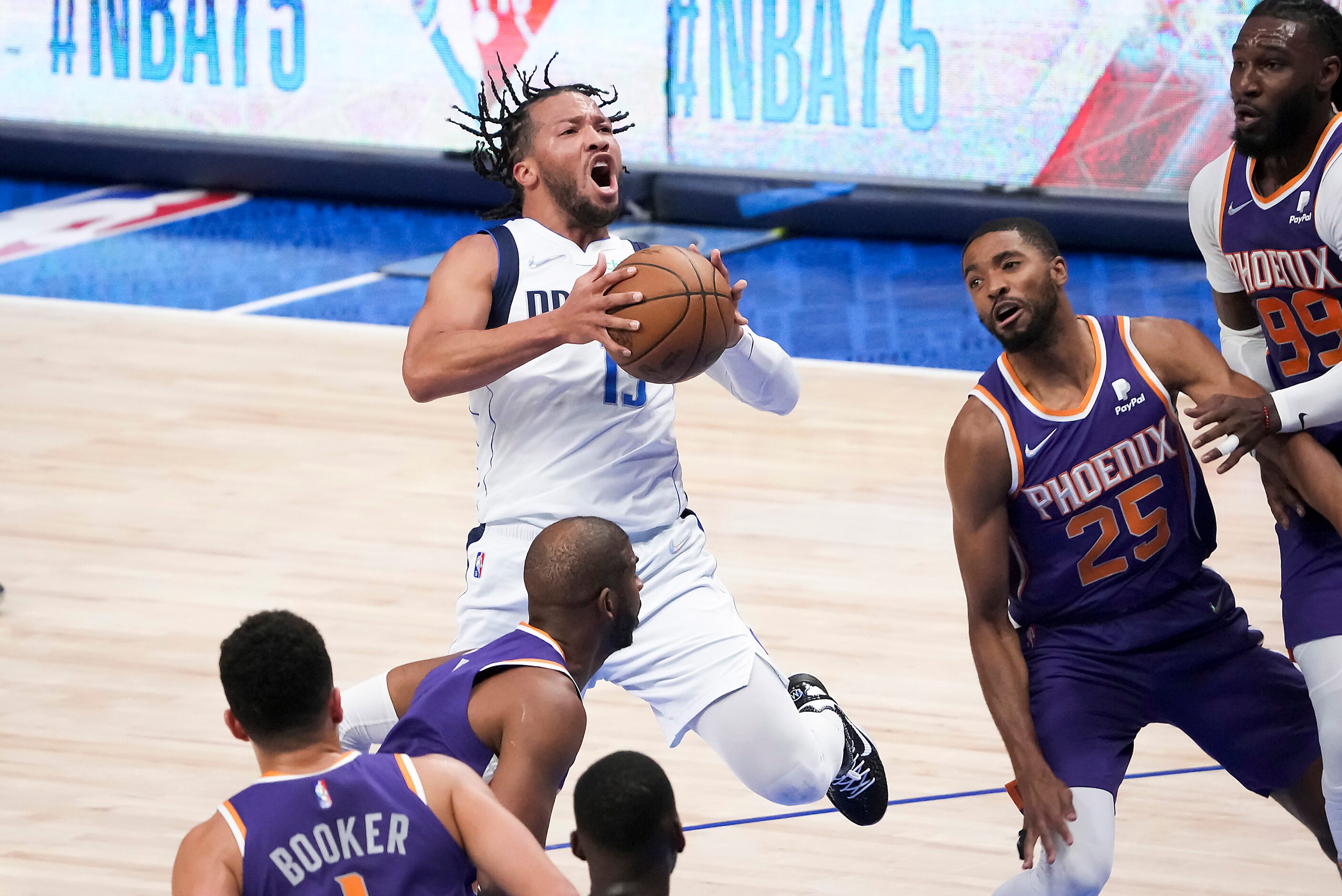 Dallas Mavericks guard Jalen Brunson (13) drives to the basket past forward Jae Crowder...