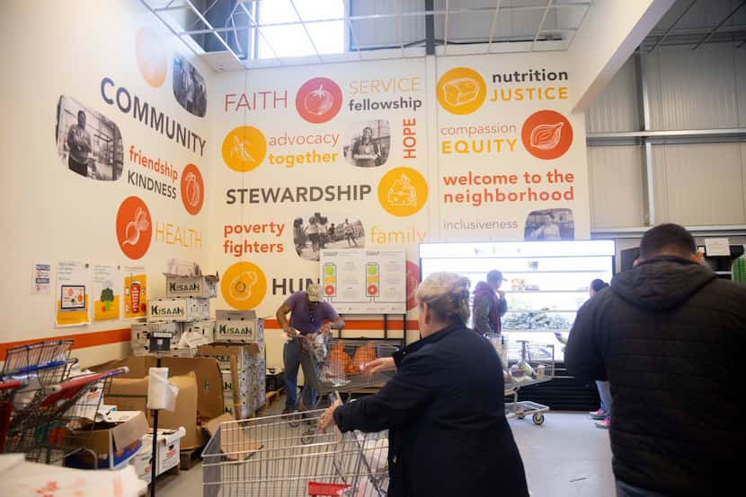 Neighbors gather groceries at the food pantry at CitySquare on Wednesday.