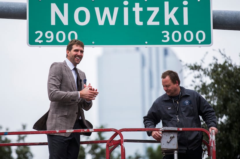 Retired Dallas Mavericks player Dirk Nowitzki unveils a street sign with his name on...