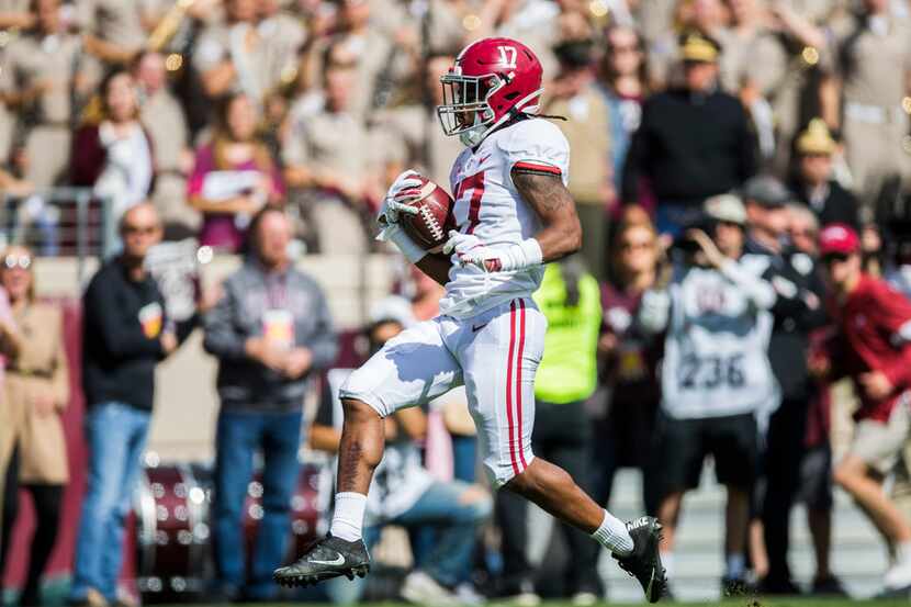 FILE - Alabama wide receiver Jaylen Waddle (17) scores a touchdown in the first quarter of a...