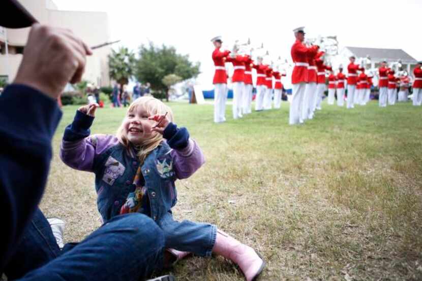 
Elizabeth Alberthal, 3, of Frisco, uses two little sticks while pretending to conduct the...