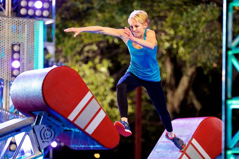 Karen Wiltin of Allen jumps from floating stair to floating stair during a taping of...