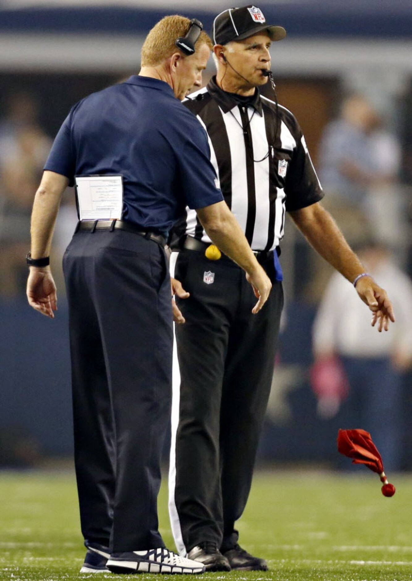 Dallas Cowboys head coach Jason Garrett throws the review flag during the first half against...