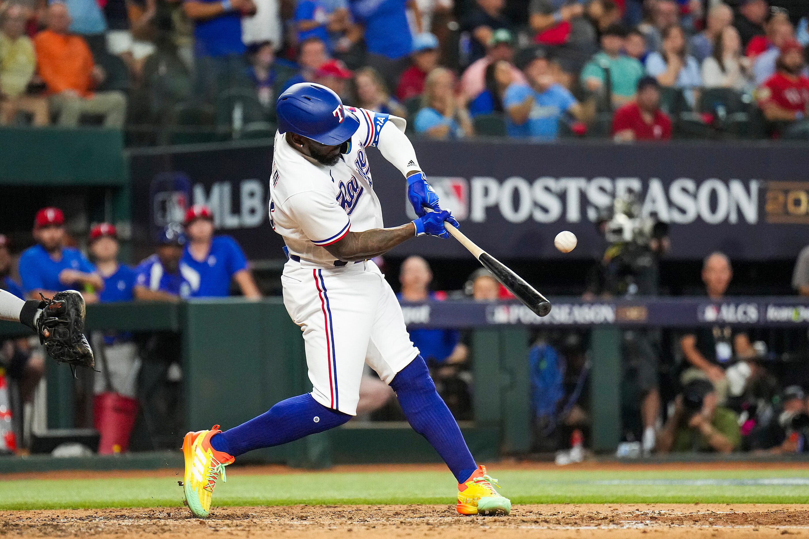 Texas Rangers right fielder Adolis Garcia hits a three-run home run during the seventh...