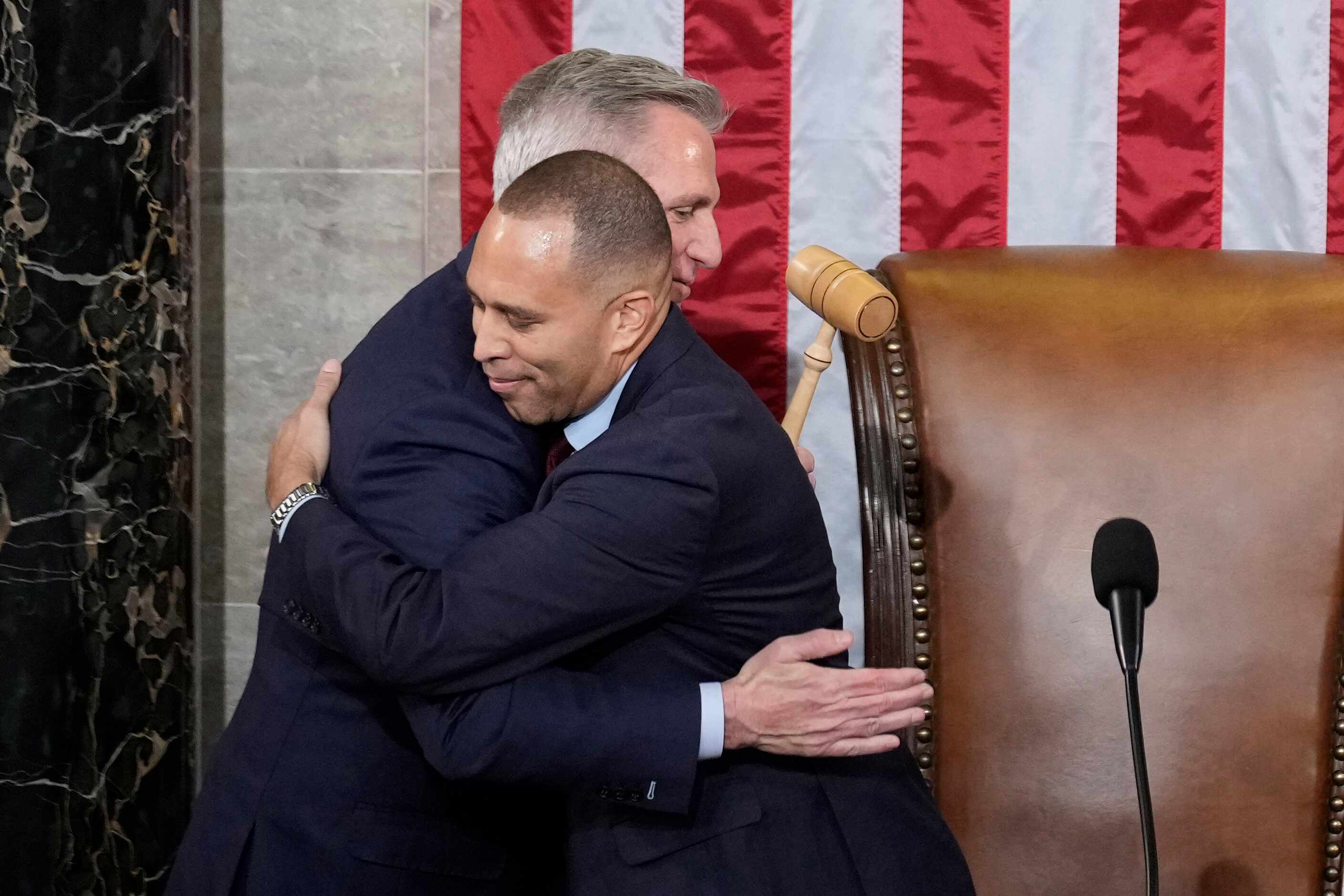 Incoming House Speaker Kevin McCarthy of Calif., hugs House Minority Leader Hakeem Jeffries...