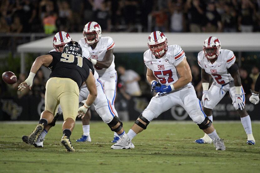 SMU offensive lineman Chad Pursley (57) sets up to block in front of Central Florida...