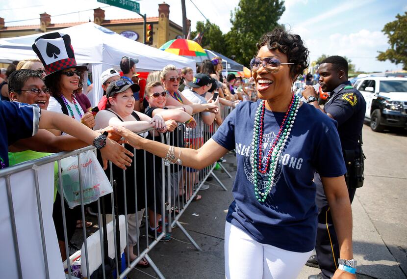 New Dallas Police Chief U. Renee Hall greets those in the crowd as she walked in the parade. 