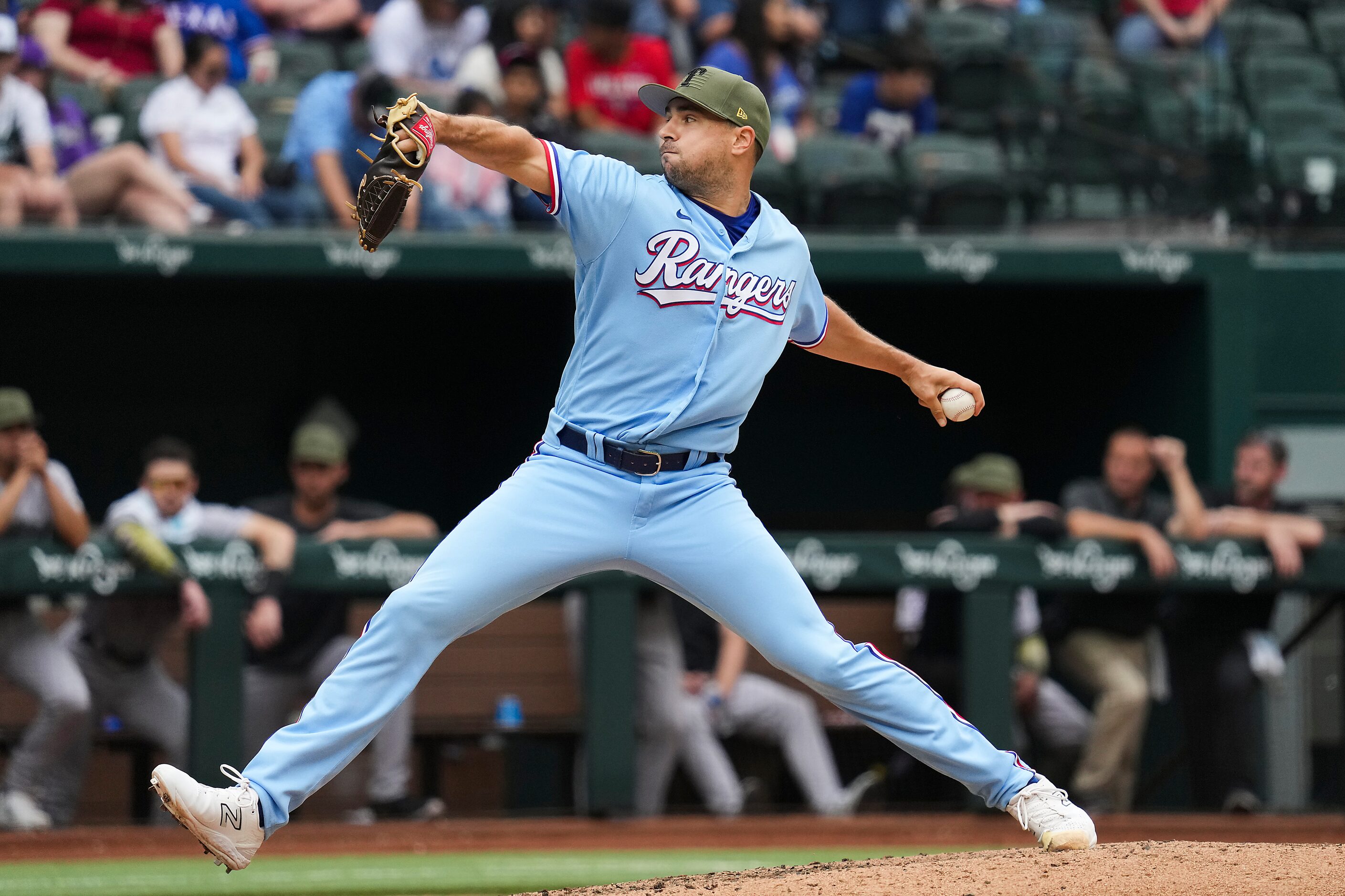 Texas Rangers relief pitcher Brock Burke delivers during the ninth inning against the...