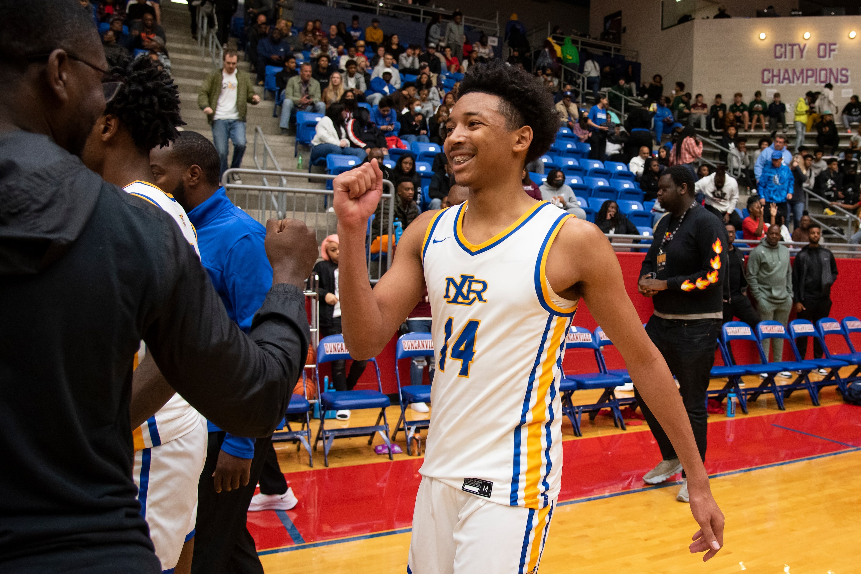 North Little Rock senior Nick Smith (14) fist bumps a teammate following Kimball's...