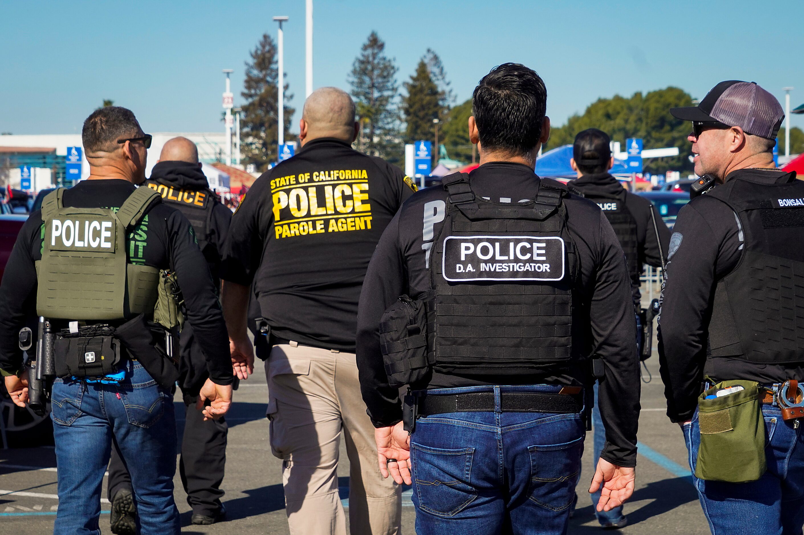 Law enforcement personnel patrol the parking lot as fans tailgate before an NFL divisional...