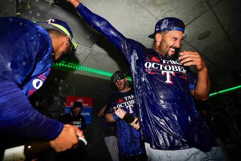 Texas Rangers second baseman Marcus Semien, right, celebrates clinching a playoff spot in...