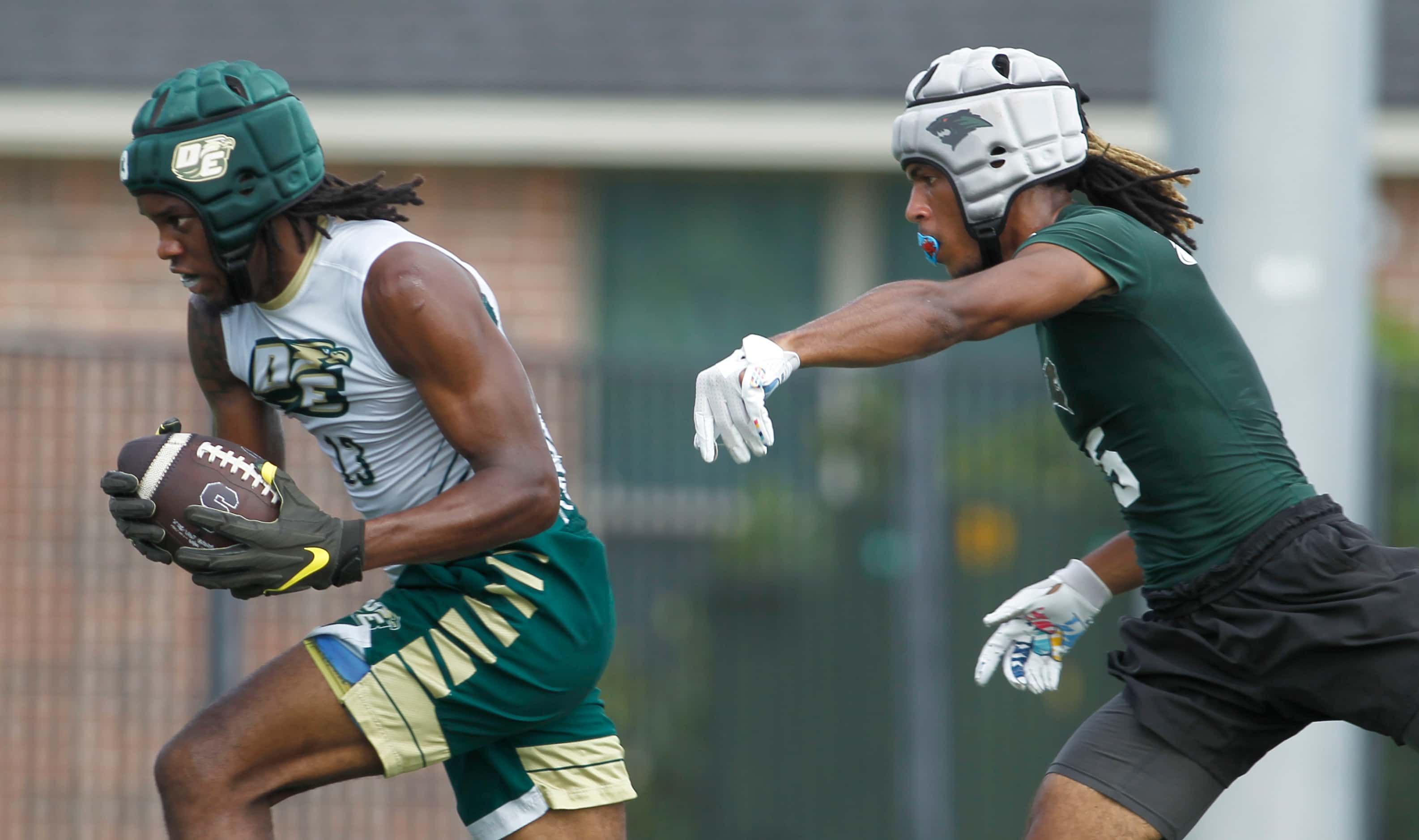 DeSoto receiver Daylon Singleton (13) secures the long pass and scores ahead of the pursuit...