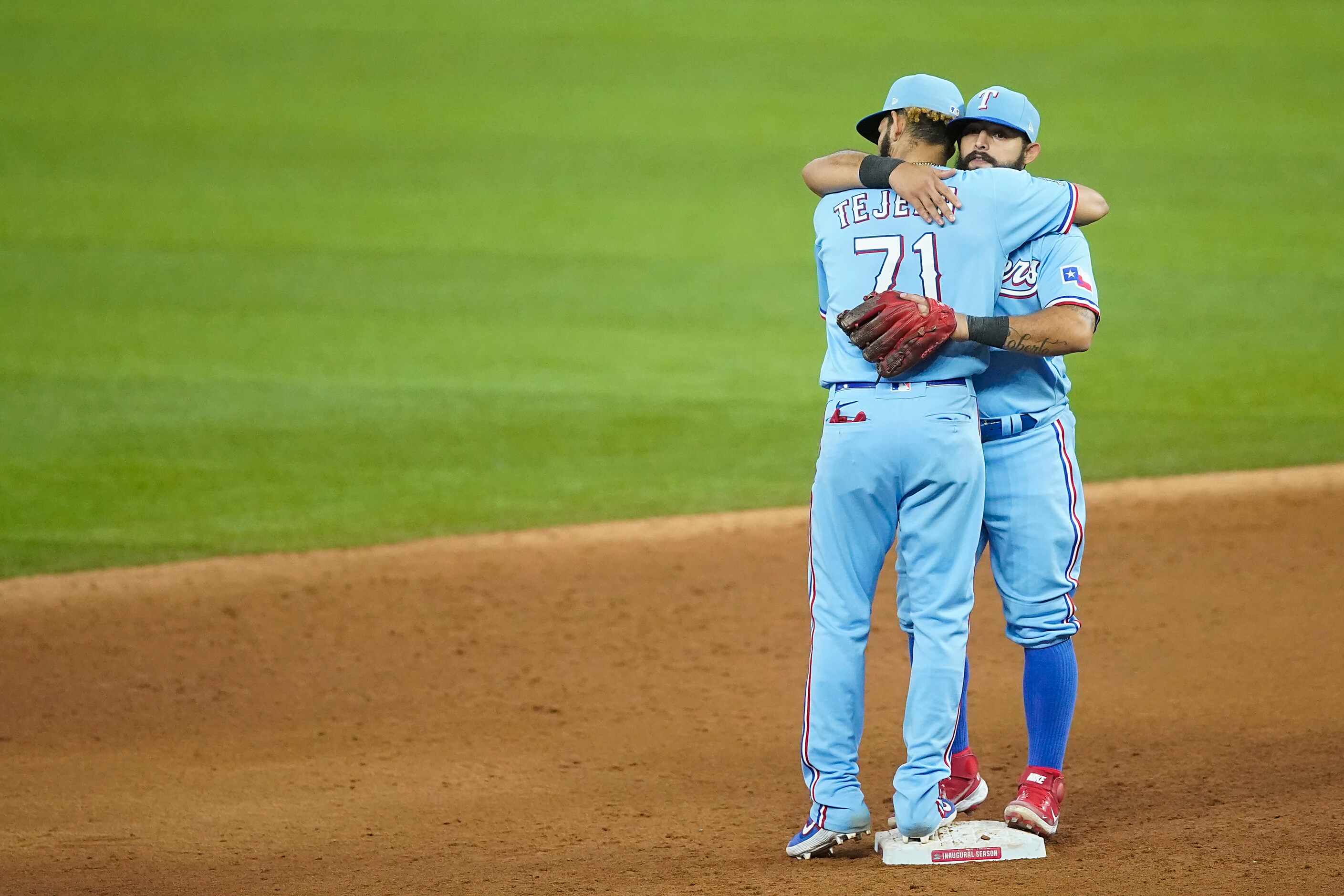 Texas Rangers second baseman Rougned Odor hugs shortstop Anderson Tejeda after an 8-4 win...
