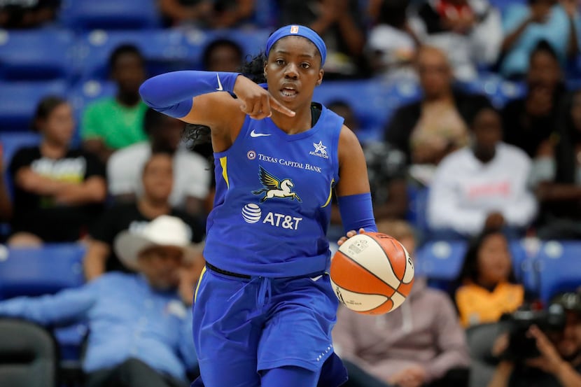 Dallas Wings guard Arike Ogunbowale directs the offense during the second half of the team's...