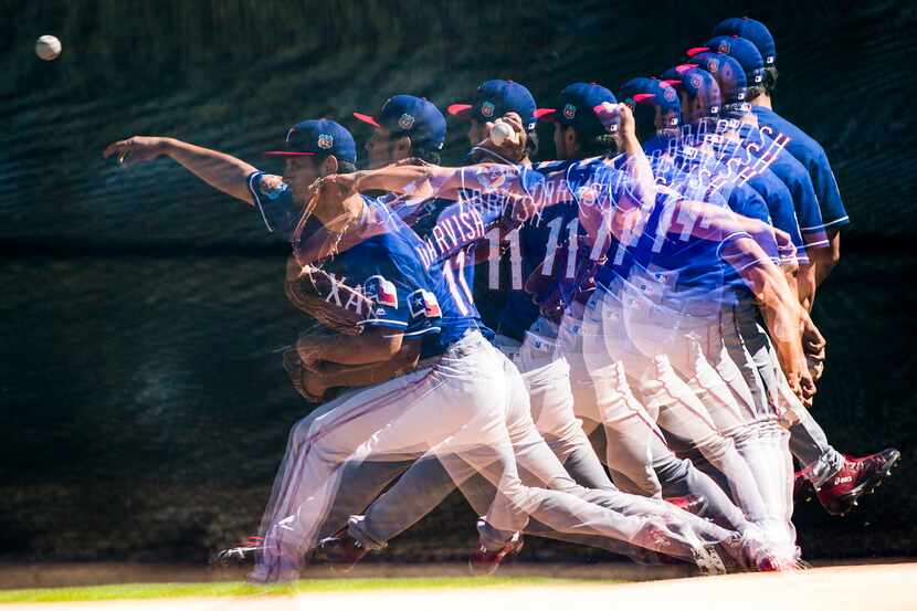 A multiple exposure photograph shows Texas Rangers pitcher Yu Darvish as the throws in the...