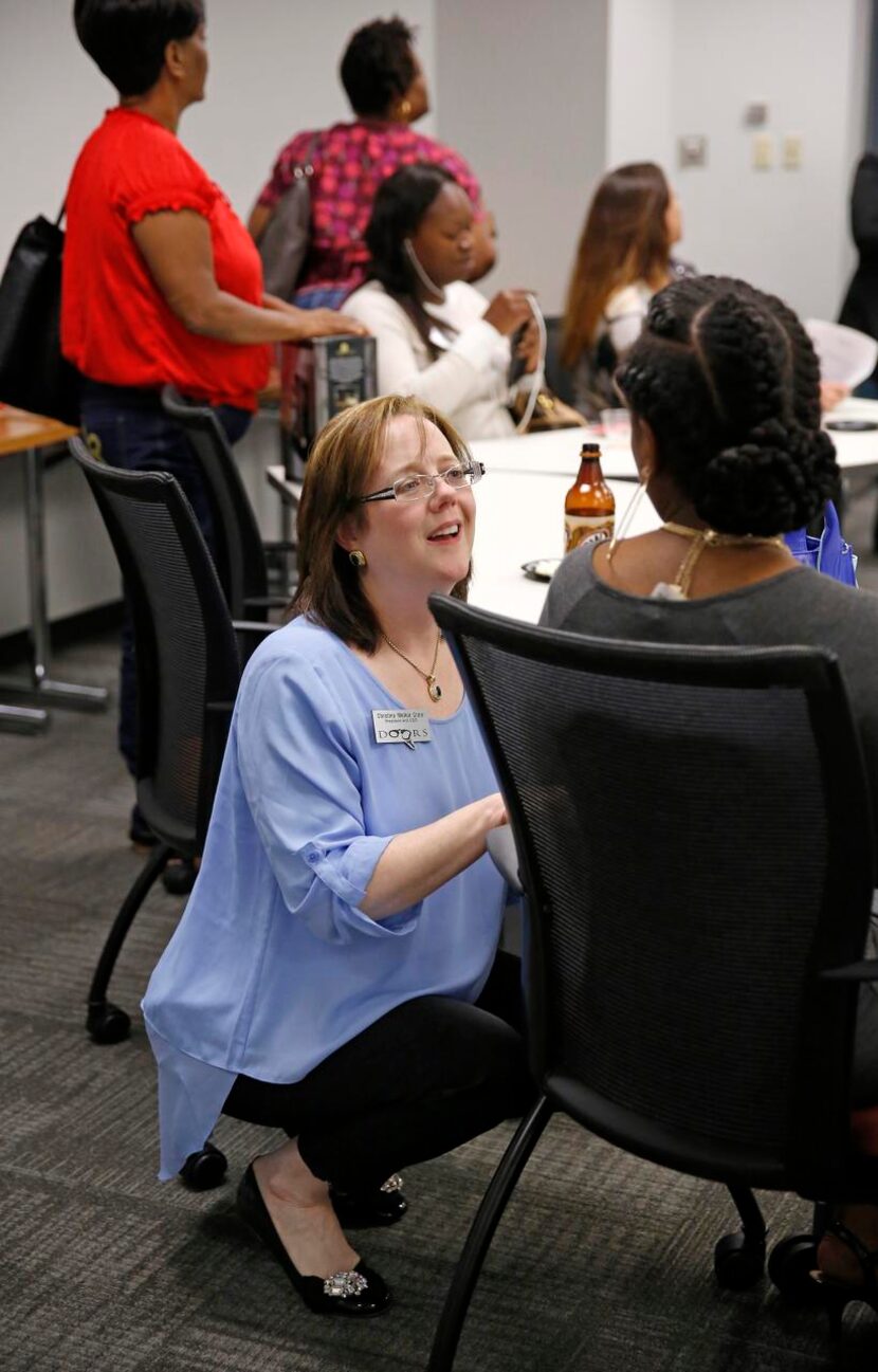 
Unlocking DOORS founder, president and CEO Christina Melton Crain (left) visits with...