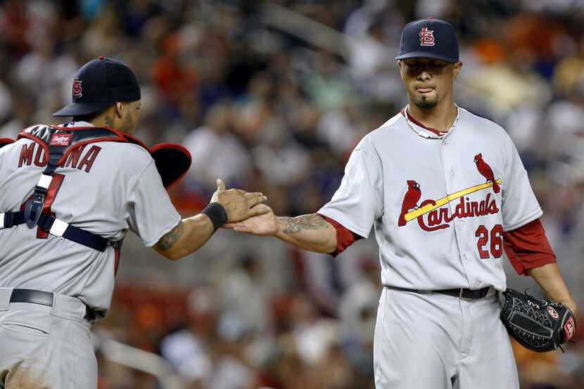 St. Louis Cardinals starting pitcher Kyle Lohse (26) is congratulated by catcher Yadier...