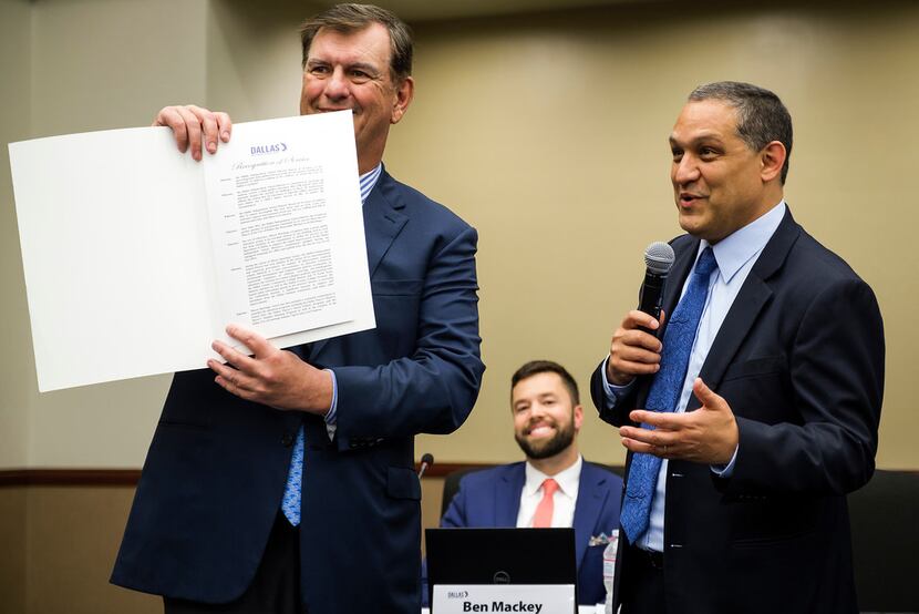 Dallas Mayor Mike Rawlings displays his Recognition of Service proclamation presented to him...