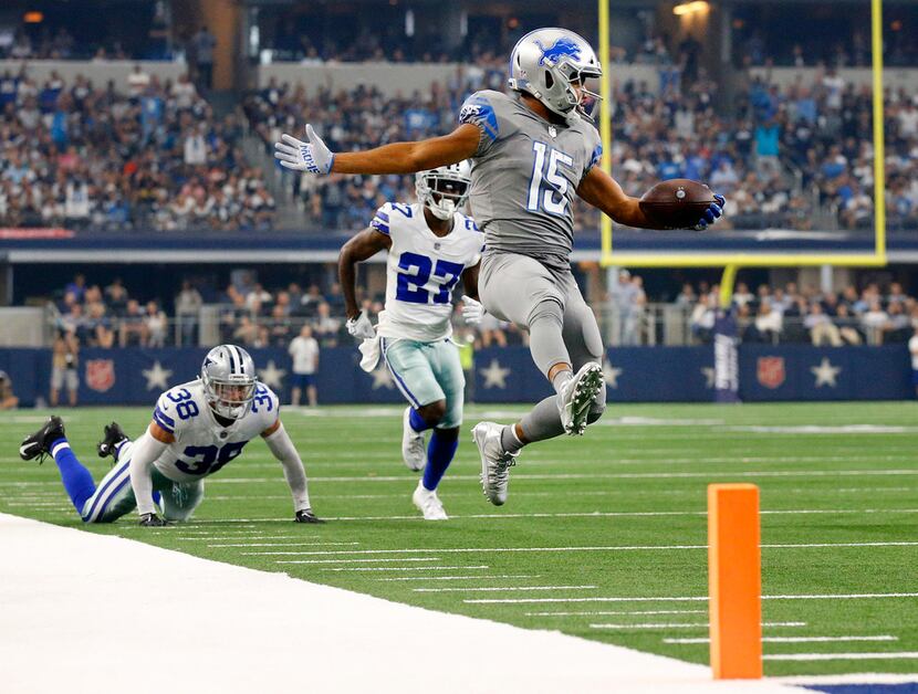 Detroit Lions wide receiver Golden Tate (15) skips to the end zone before stopping and...