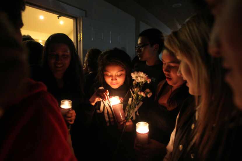 Classmate Cindy Chevez, 14, (center) joined other students  paying respects to Surie Baeza...