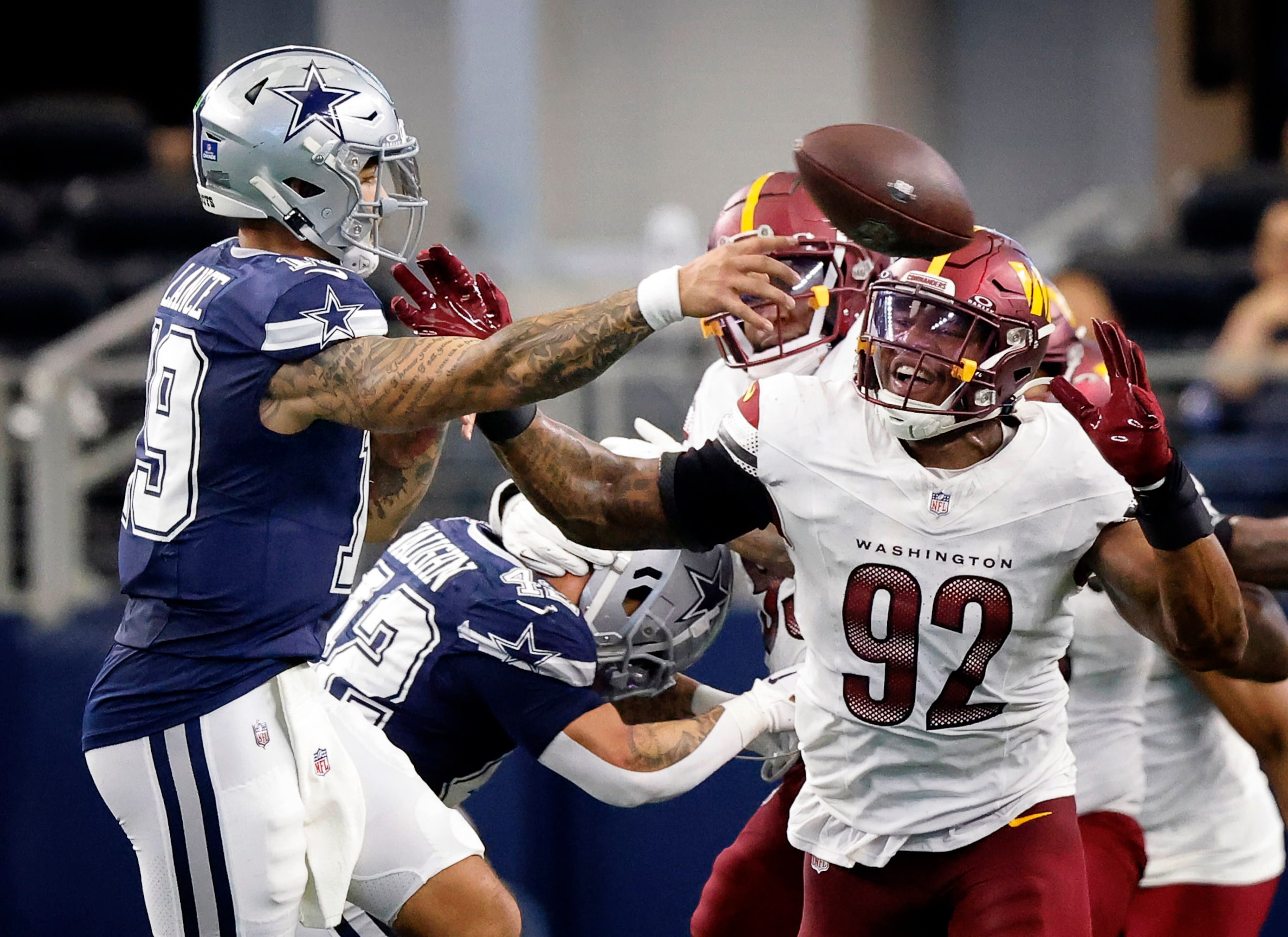 Dallas Cowboys quarterback Trey Lance (19) throws under pressure from Washington Commanders...