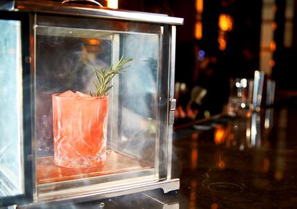 A Smoke and Rosemary at Beau Nash cocktail bar at Hotel Crescent in Dallas mixes tequila,...