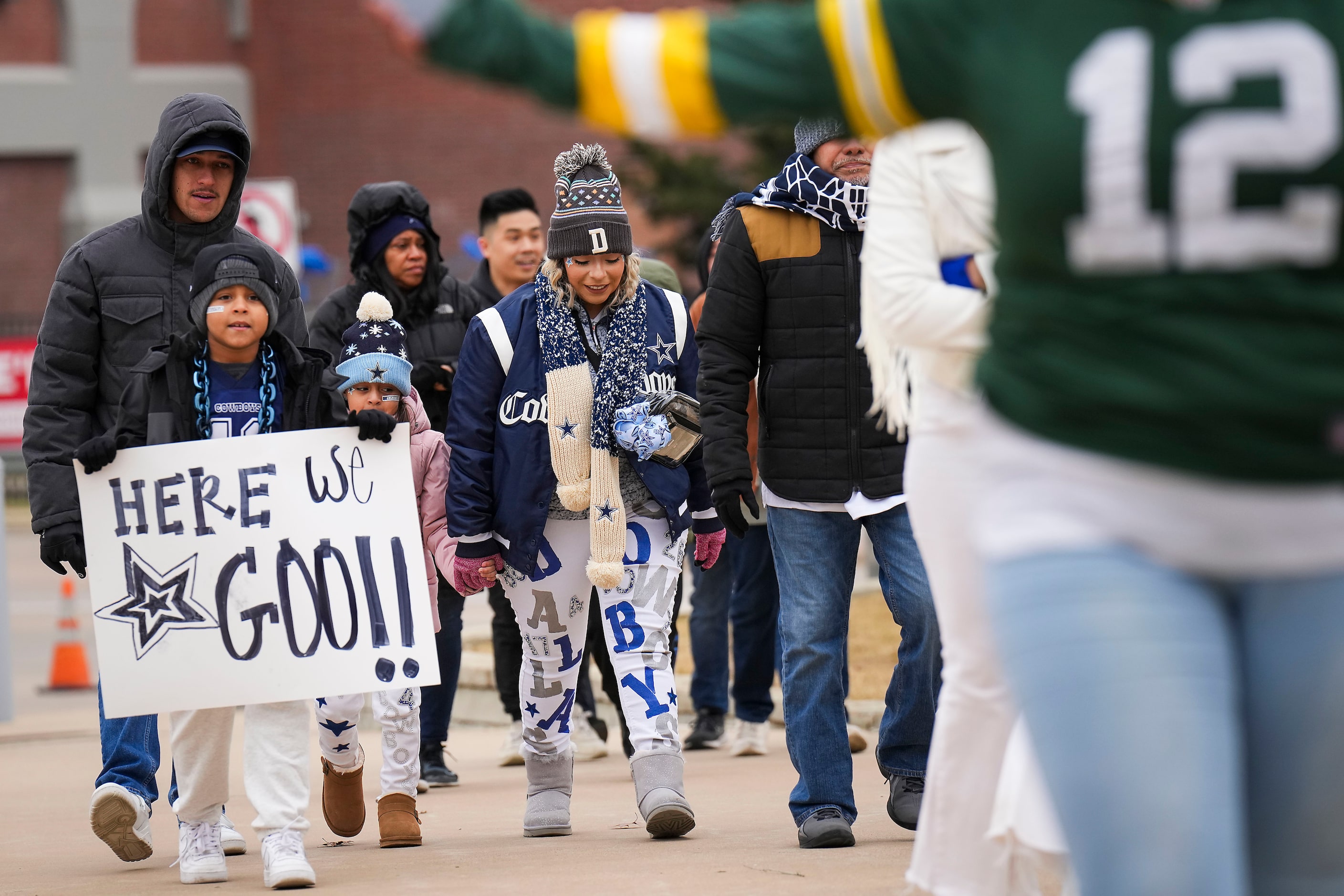 Dallas Cowboys fan Liam Magellan of Houston carries a sign reading “Here We Go!” as he...