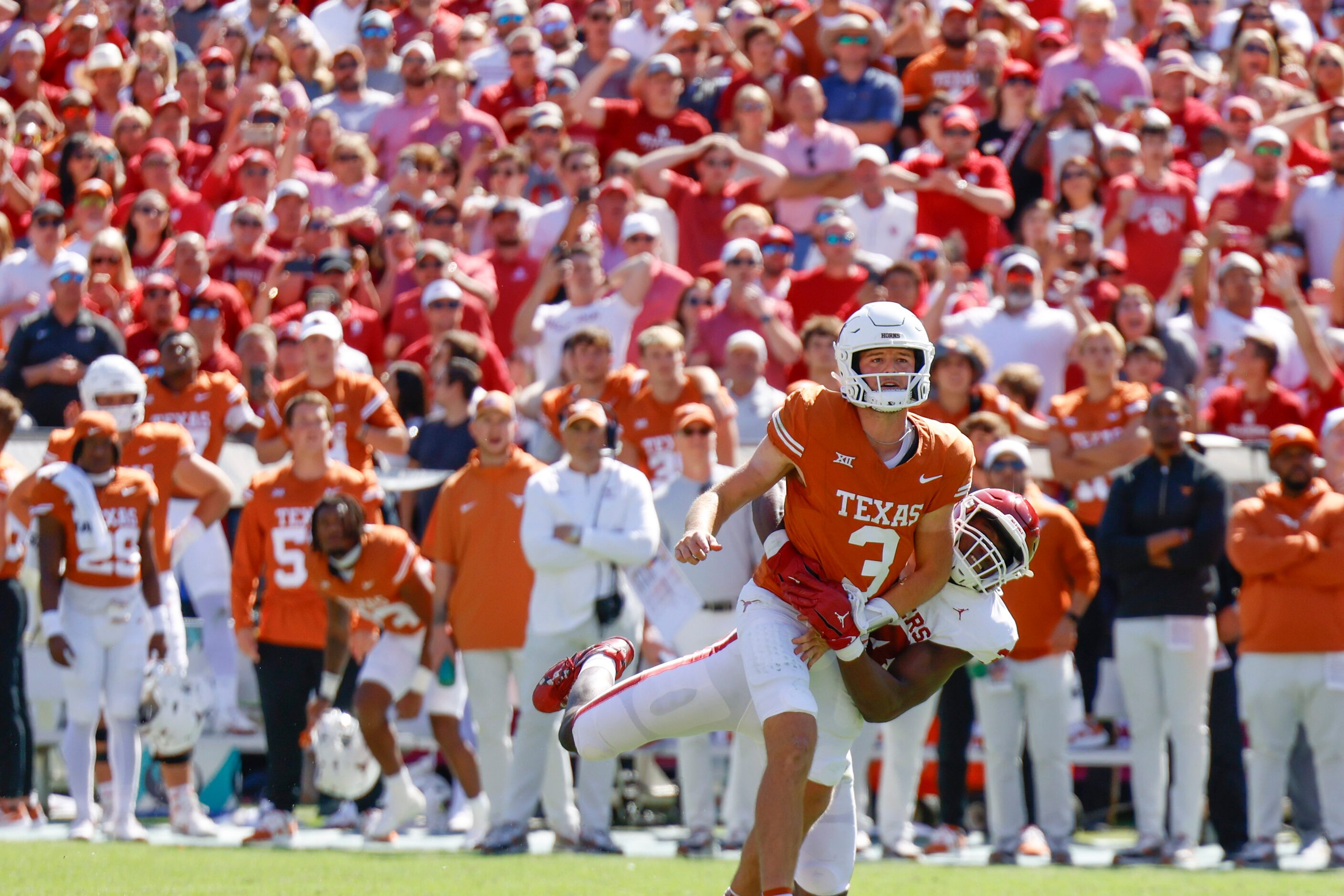 Texas quarterback Quinn Ewers gets tackled by Oklahoma defensive lineman Adepoju Adebawore...