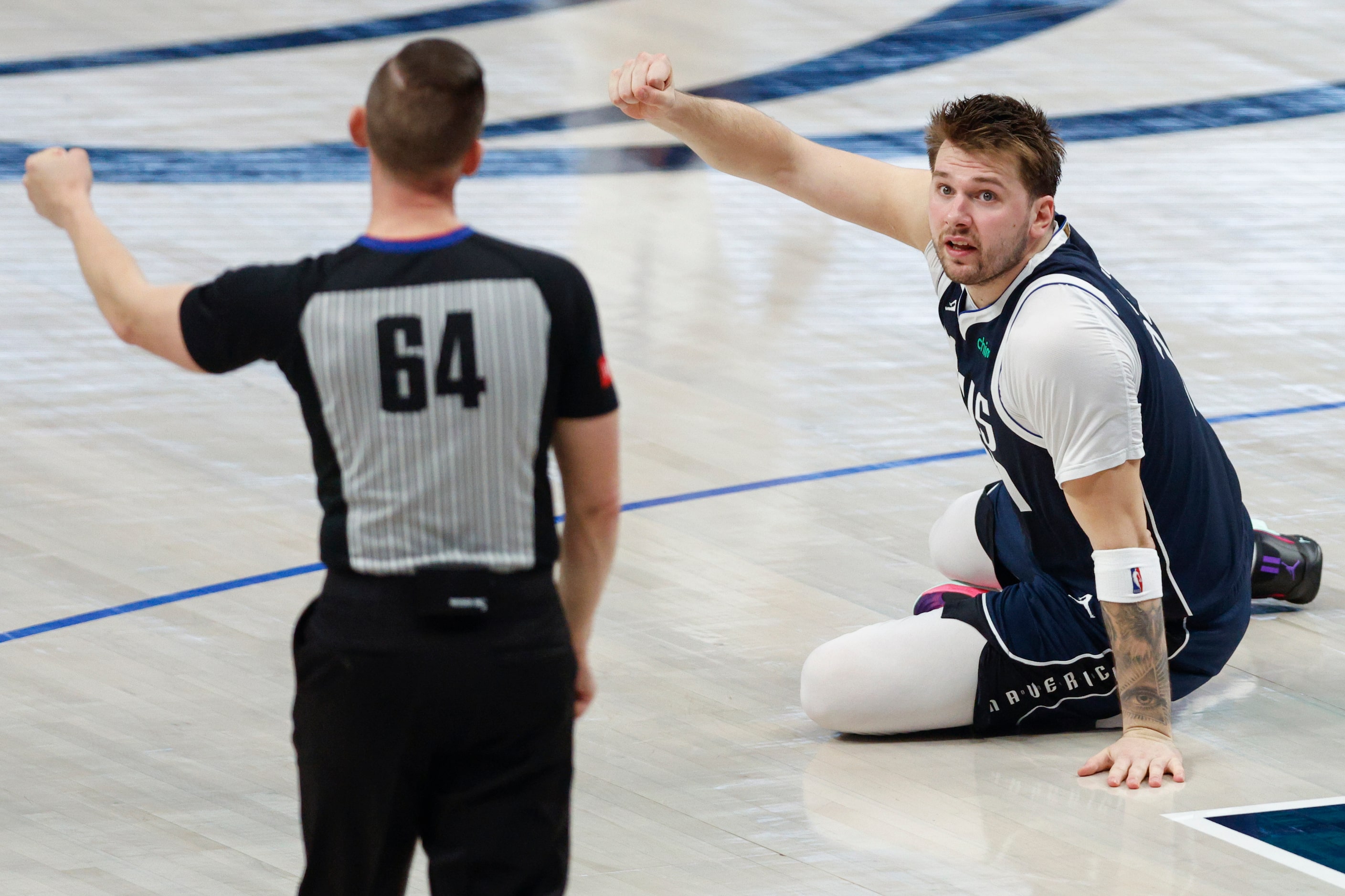 Dallas Mavericks guard Luka Doncic (77) looks to referee Justin Van Duyne (64) for a foul...