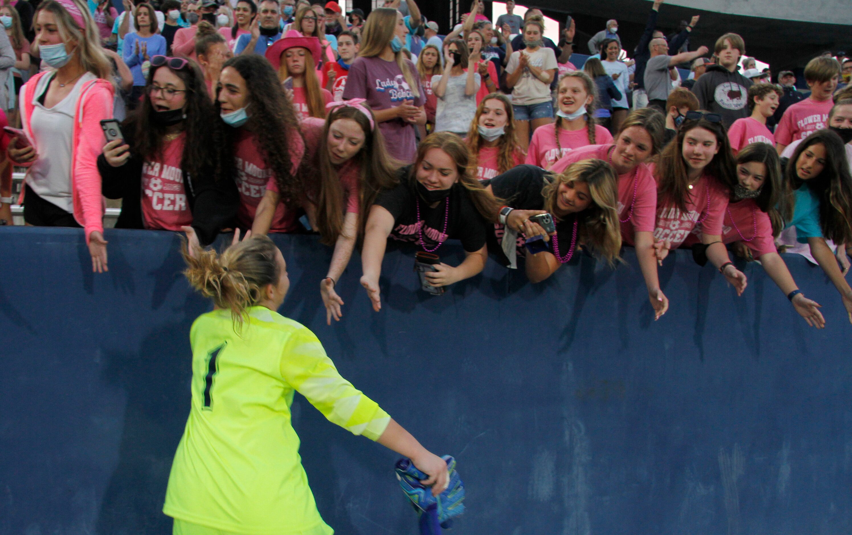 Flower Mound goal keeper Peyton Whipple (1) runs through a celebratory reception line as she...