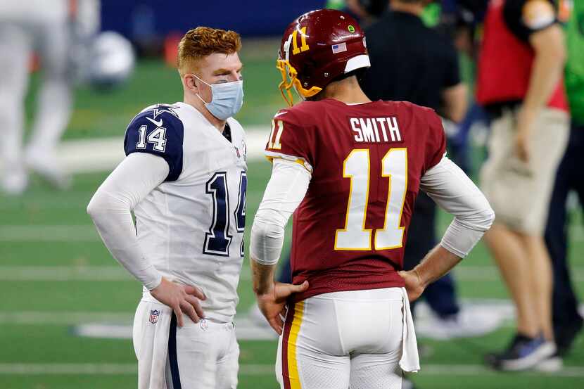 Wearing a mask, Dallas Cowboys quarterback Andy Dalton (14) visits with Washington Football...