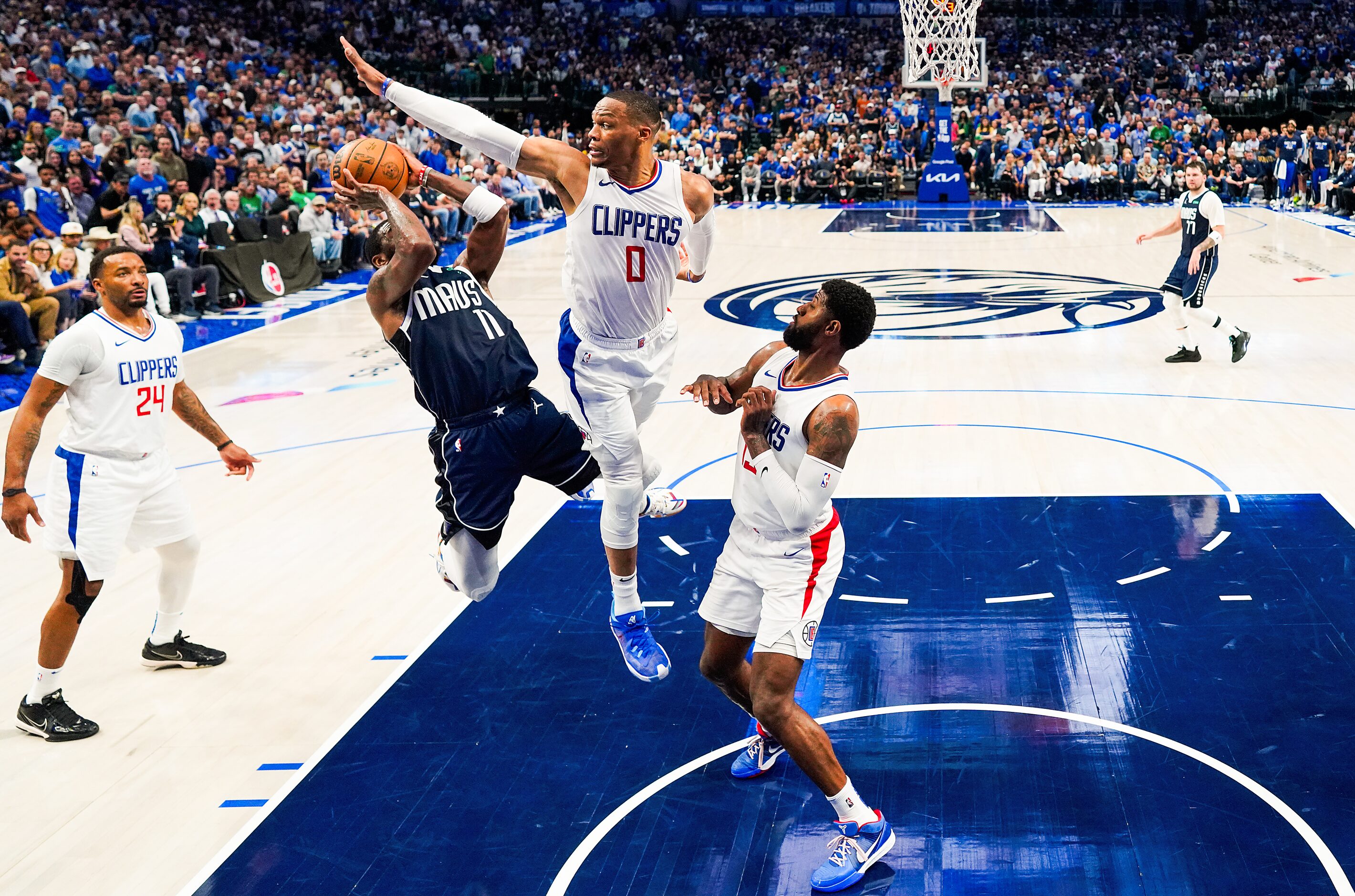 Dallas Mavericks guard Kyrie Irving (11) is fouled by LA Clippers guard Russell Westbrook...