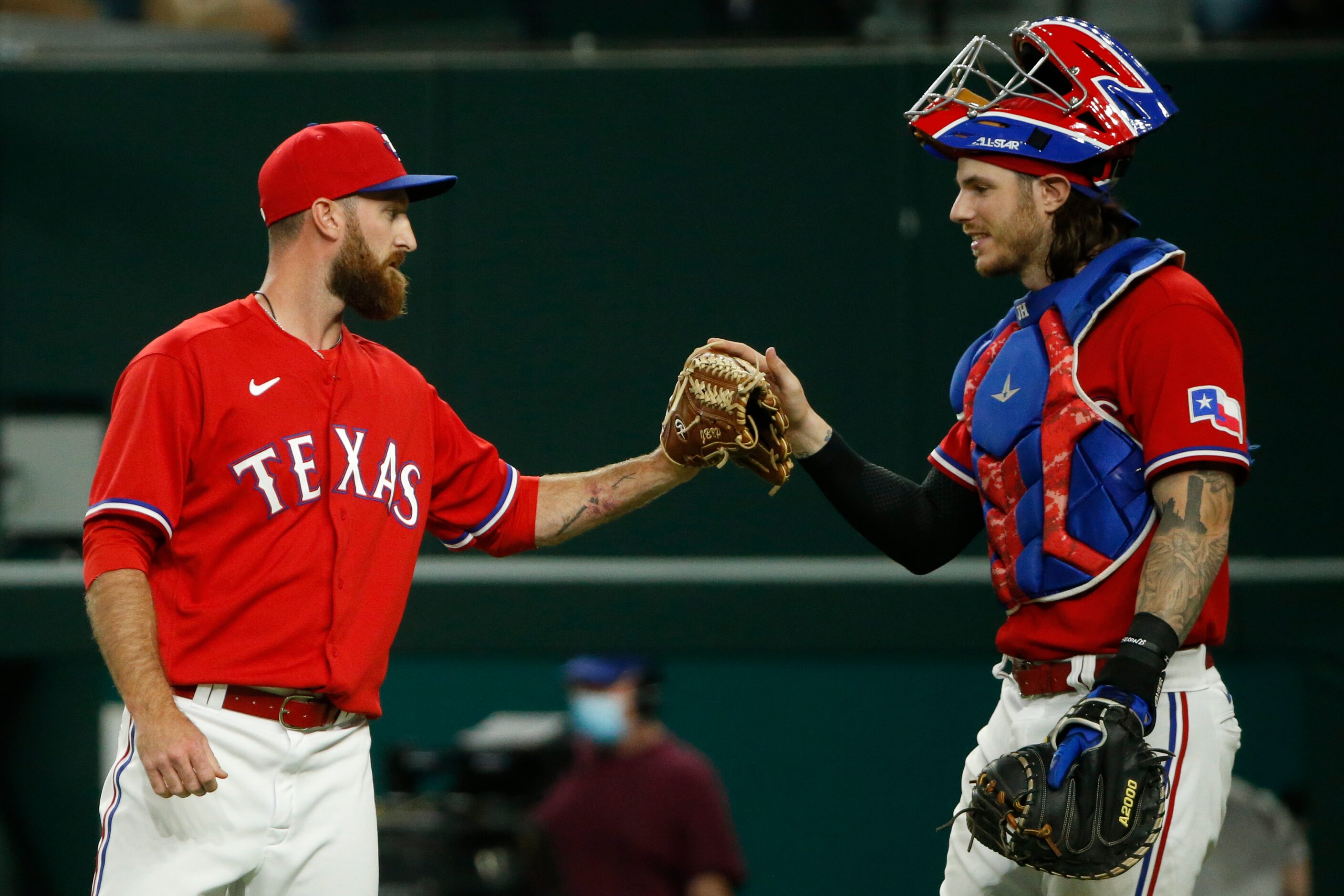 Texas Rangers relief pitcher Spencer Patton (61) celebrates a 9-4 win with catcher Jonah...