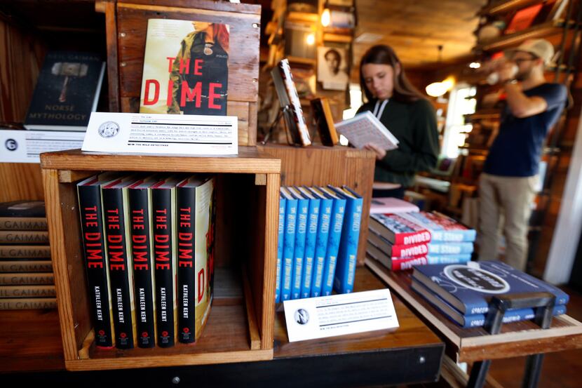 The Wild Detectives book display is made of repurposed wood and has labels of information...