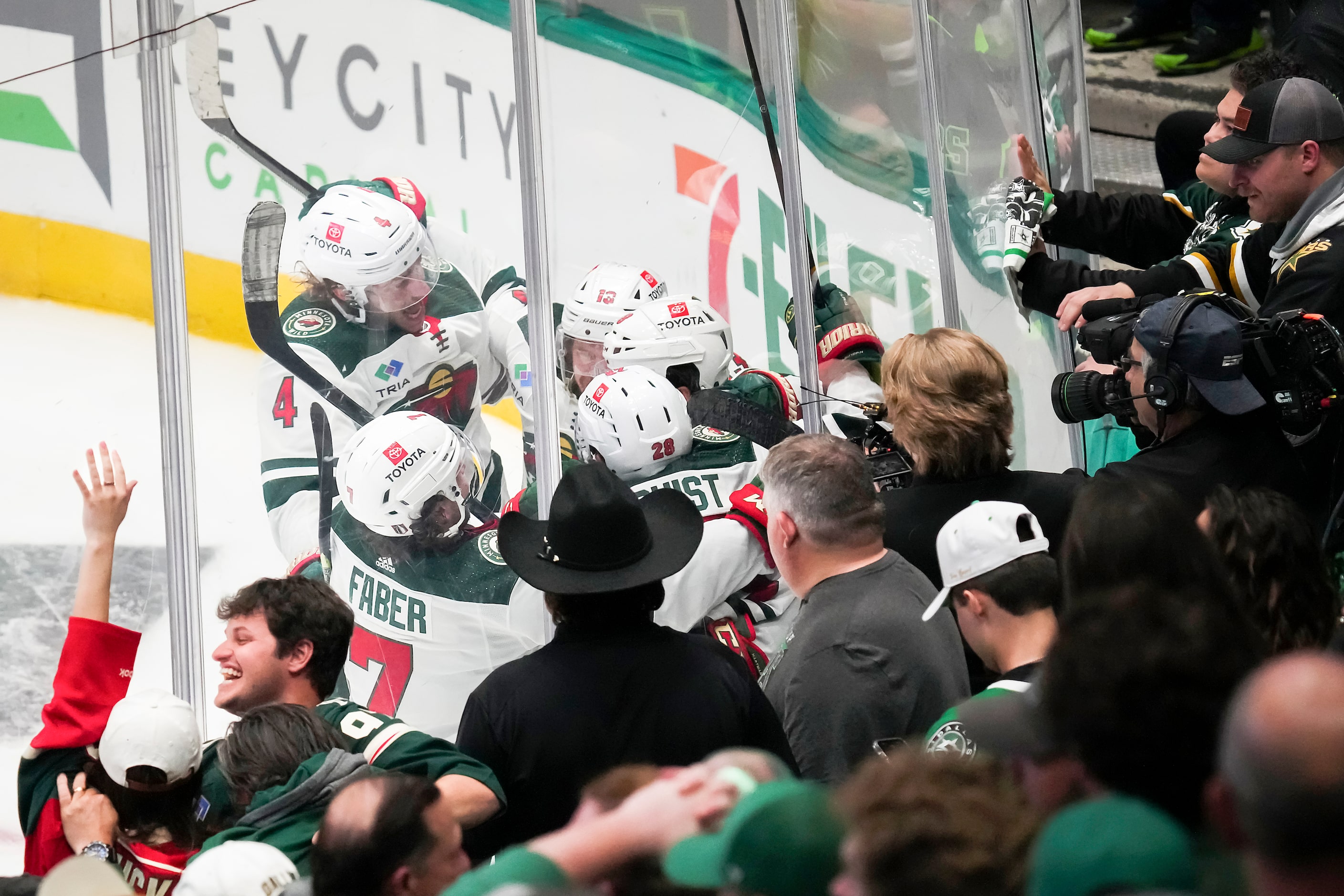 Minnesota Wild players celebrate around right wing Ryan Hartman after he scored the game...