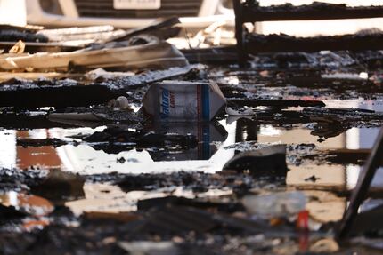 Chared remains in a breezeway are seen following a fire at the Oak Meadows Apartments on...