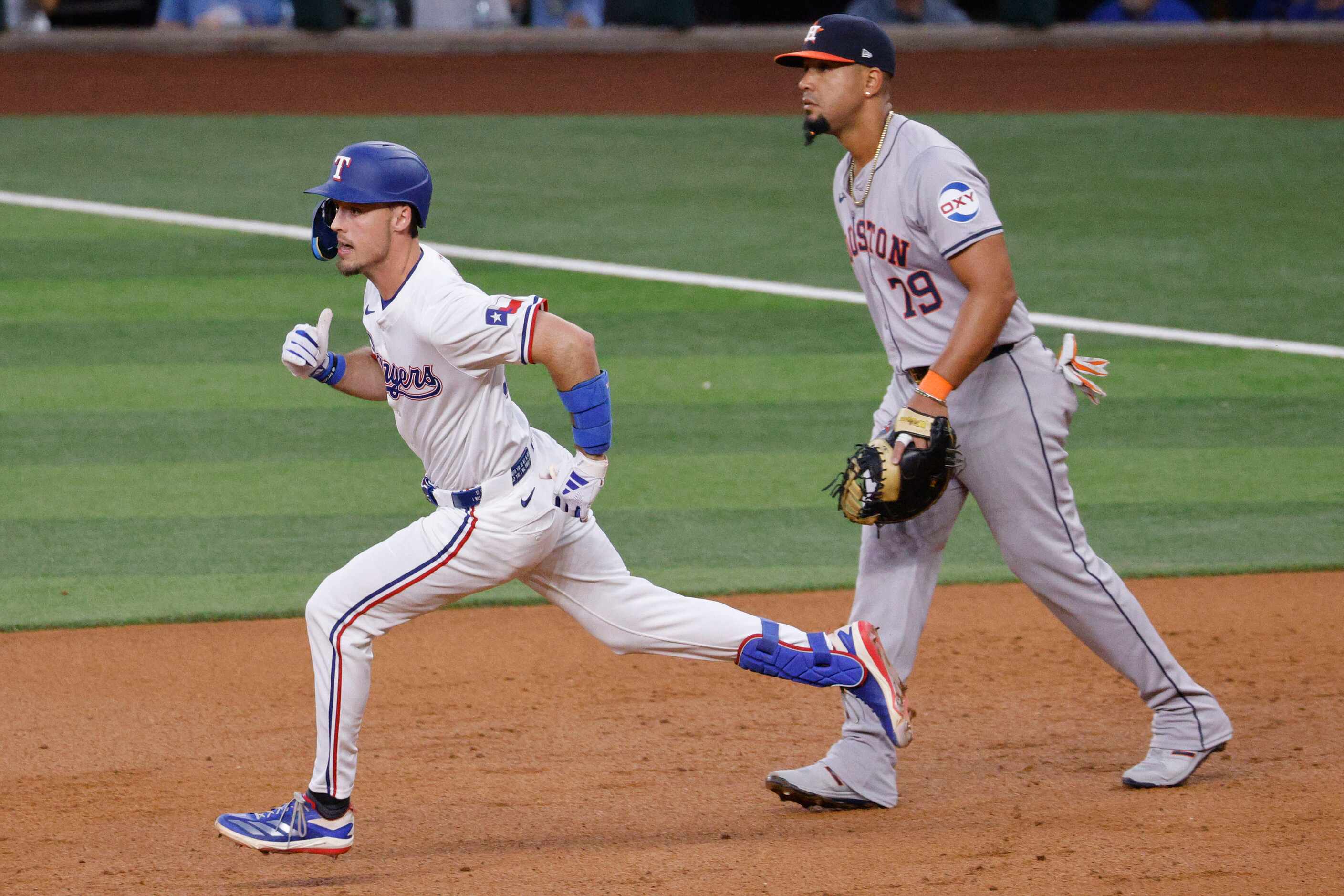 Texas Rangers outfielder Evan Carter (32) runs after he hit a double as Houston Astros first...