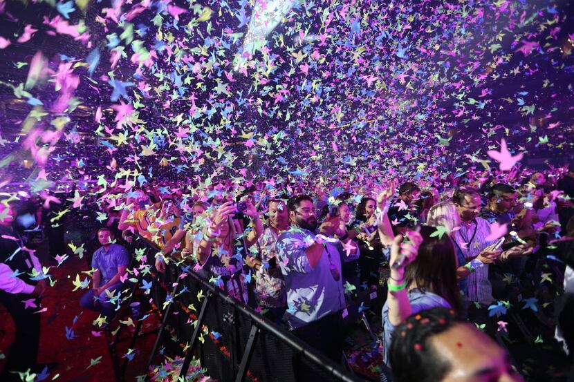 Coldplay fans enjoy the confetti canons during the band's concert at AT&T Stadium, Saturday,...