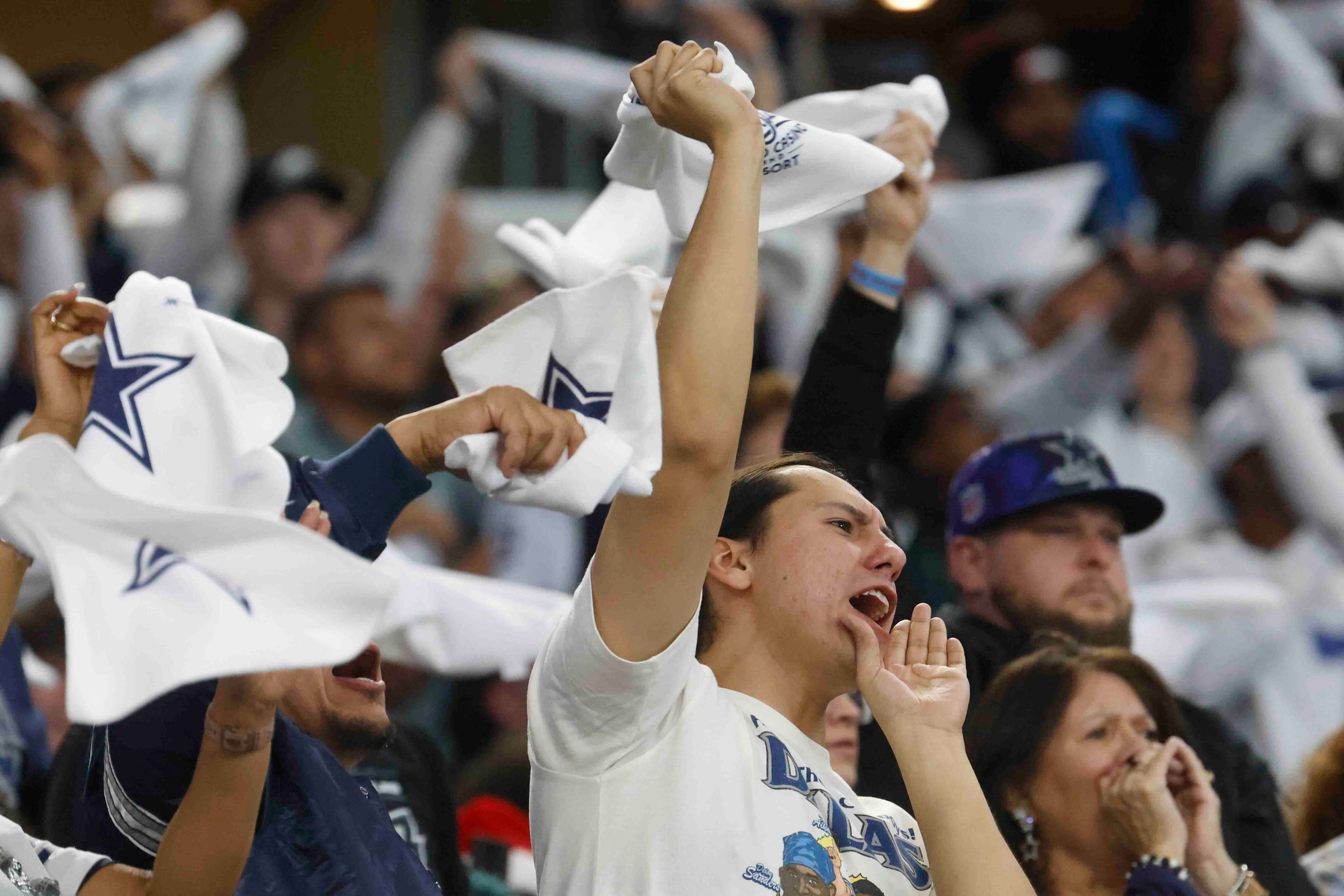 Dallas Cowboys fans cheers during the first half of an NFL football game against...