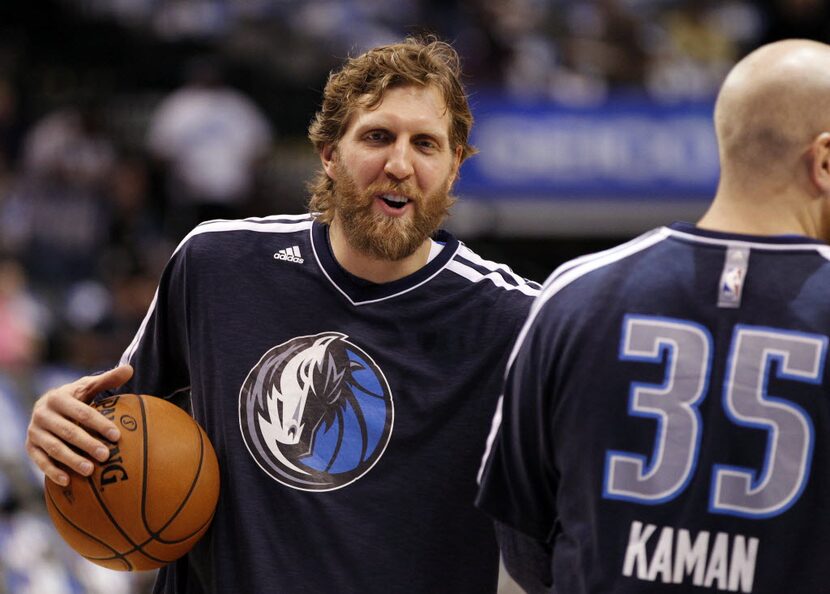 FILE - Dirk Nowitzki (41) jokes around with Mavericks center Chris Kaman (35) before a game...