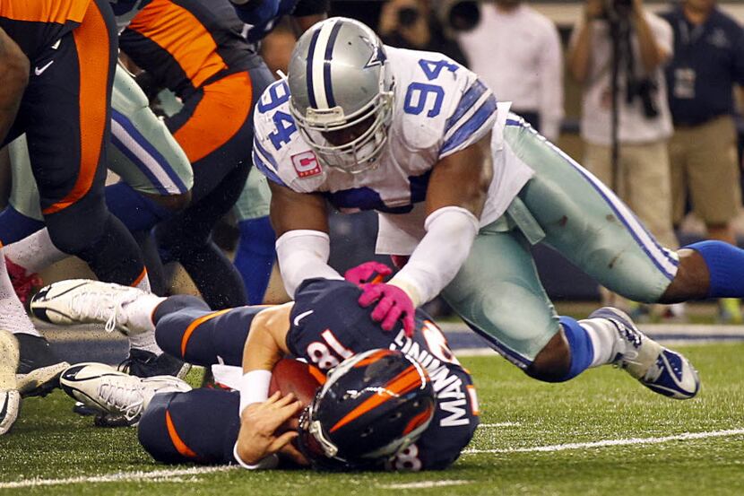 Dallas Cowboys defensive end DeMarcus Ware (94) pounces on Denver Broncos quarterback Peyton...