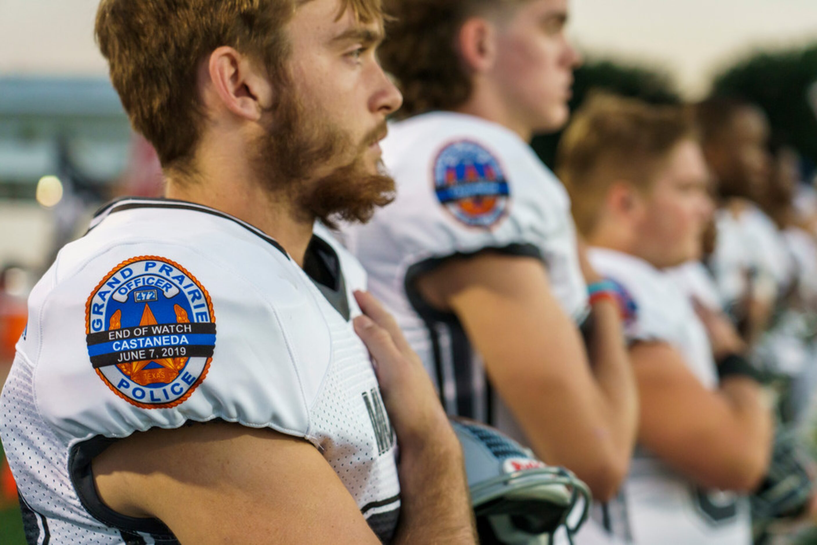 Arlington Martin players wear jerseys bearing a patch honoring Grand Prairie police officer...