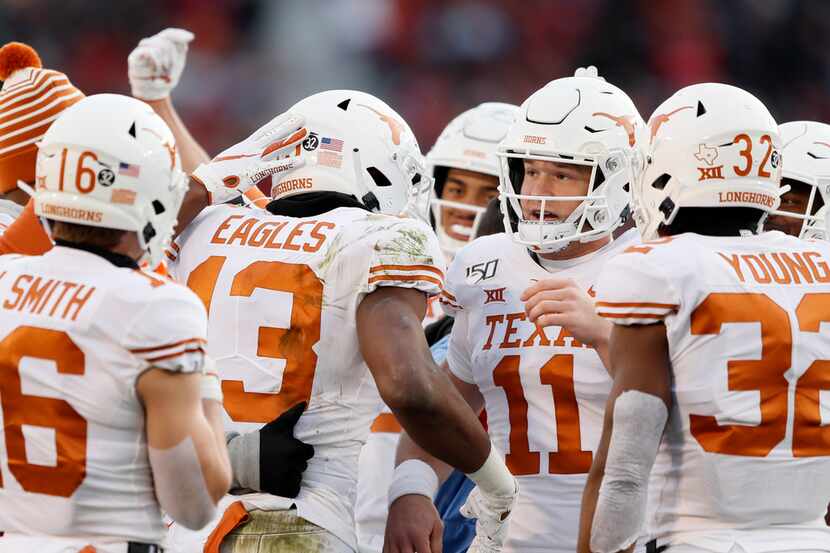 Texas wide receiver Brennan Eagles (13) celebrates with quarterback Sam Ehlinger (11) after...