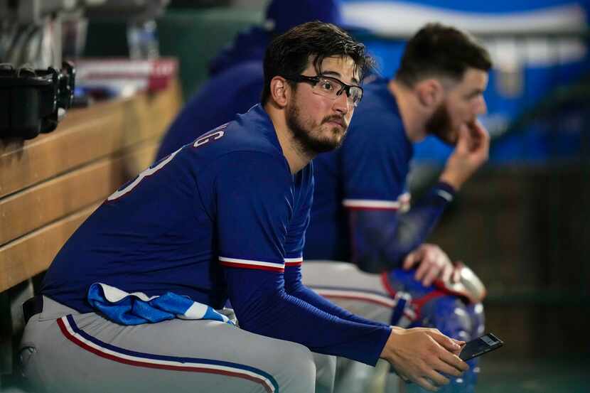 Texas Rangers starting pitcher Dane Dunning sits in the dugout during the eighth inning of a...