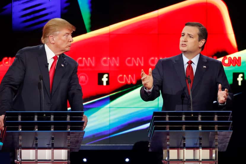  Donald Trump, left, watches as Ted Cruz speaks during the CNN Republican presidential...