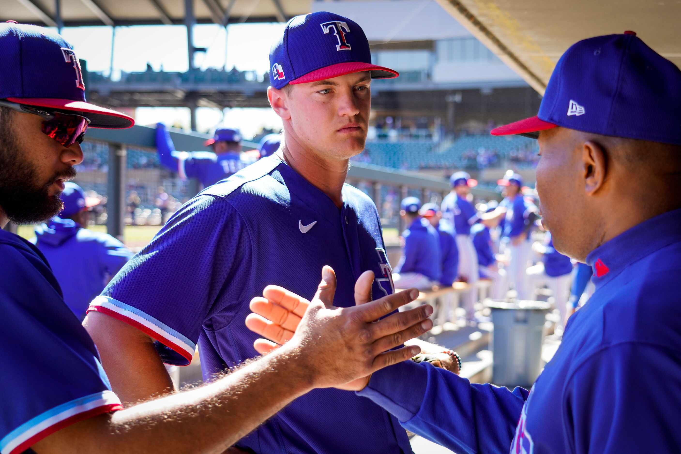 Texas Rangers third baseman Josh Jung (center) talks with third base coach Tony Beasley...