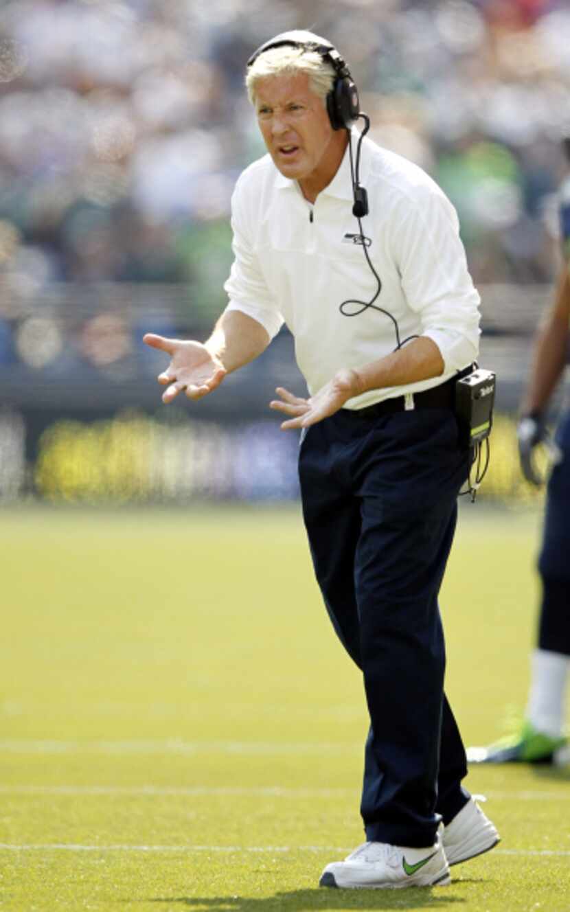Seattle Seahawks head coach Pete Carroll questions an official during the first half of play...