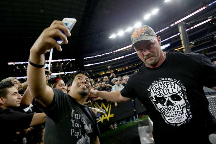 Chris Smith, cq, snaps a quick selfie with “Stone Cold” Steve Austin at the Wrestlemania...