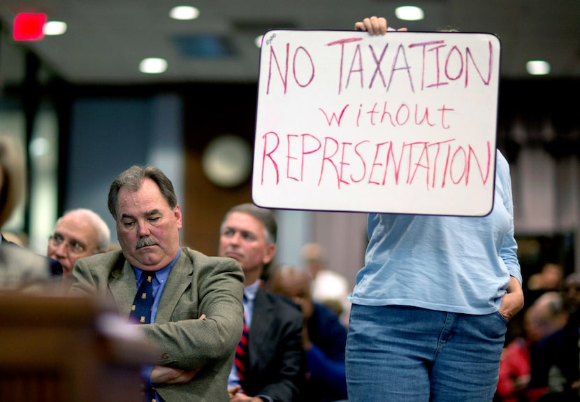 Mike Plant (left), the Atlanta Braves' president of development, listened to public comments...